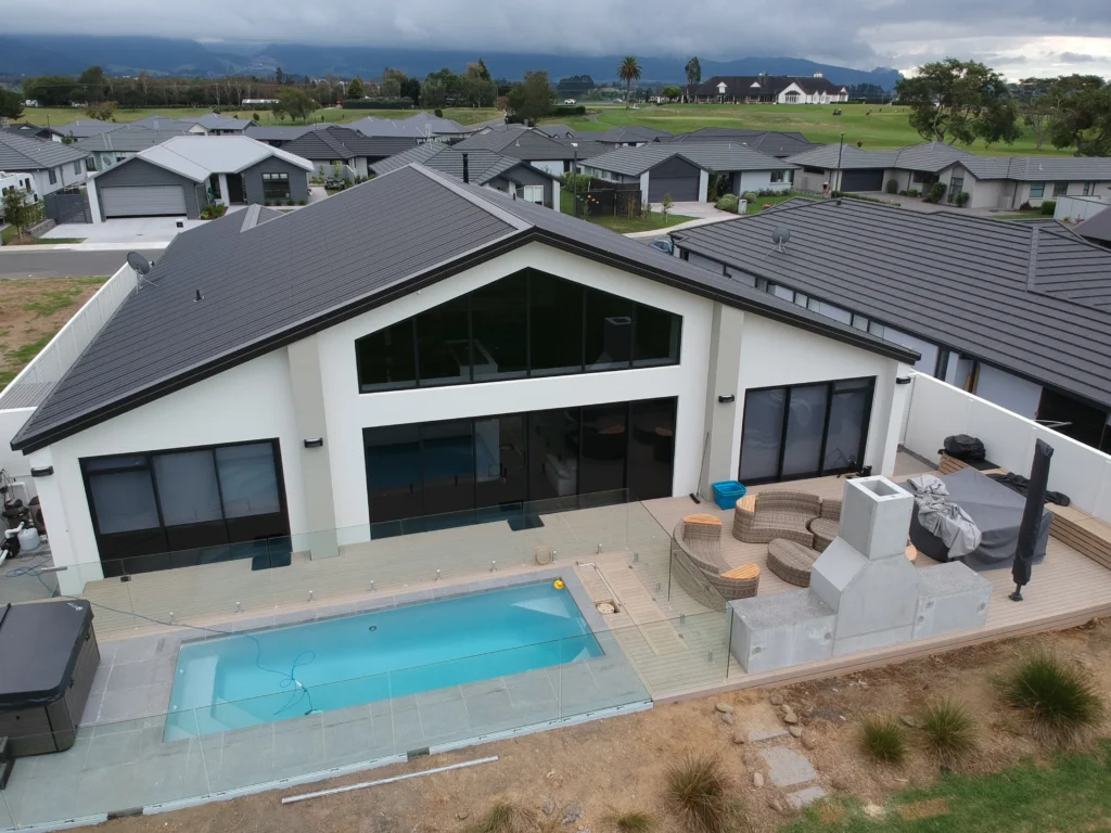 Aerial view of the completed Fairview build with an in-ground pool