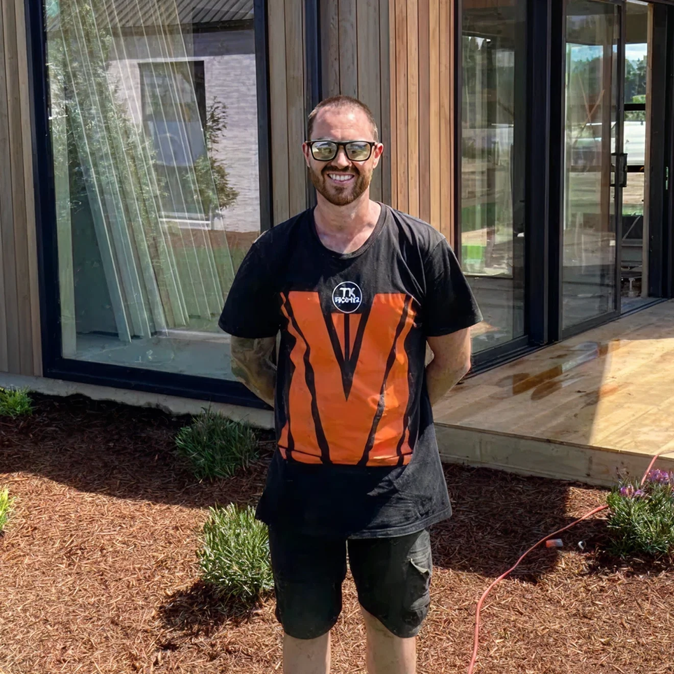 TK Homes builder outside a completed new home in Tauranga