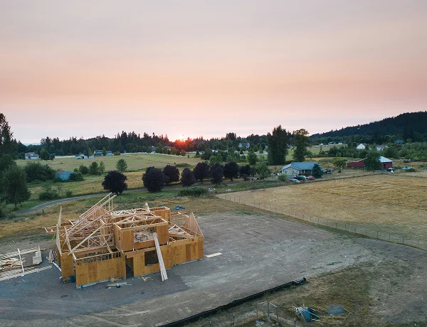 Aerial view of new house framing on a subdivision at sunset