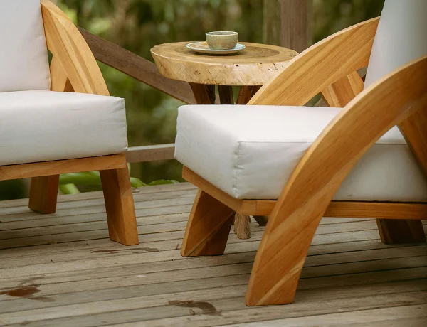 Timber outdoor chairs with cushions on a deck
