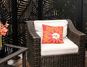 Outdoor chair beside a dark timber slat privacy screen