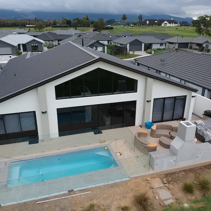 Aerial view of a completed TK Homes build with an in-ground pool