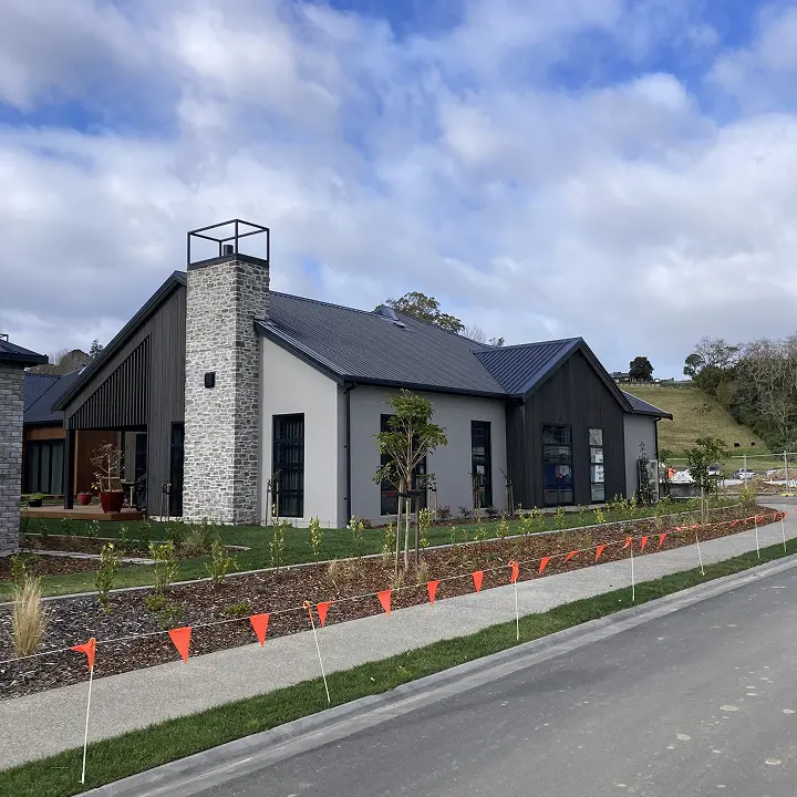 Completed home with stone and dark cladding on a Tauranga street